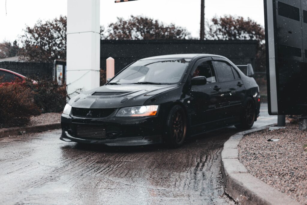 black-car-on-a-wet-driveway
